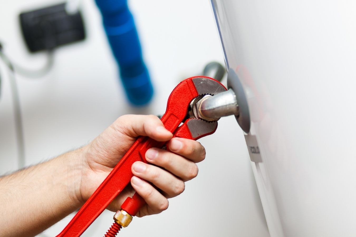 Licensed plumber performing professional hot water heater installation in a residential home