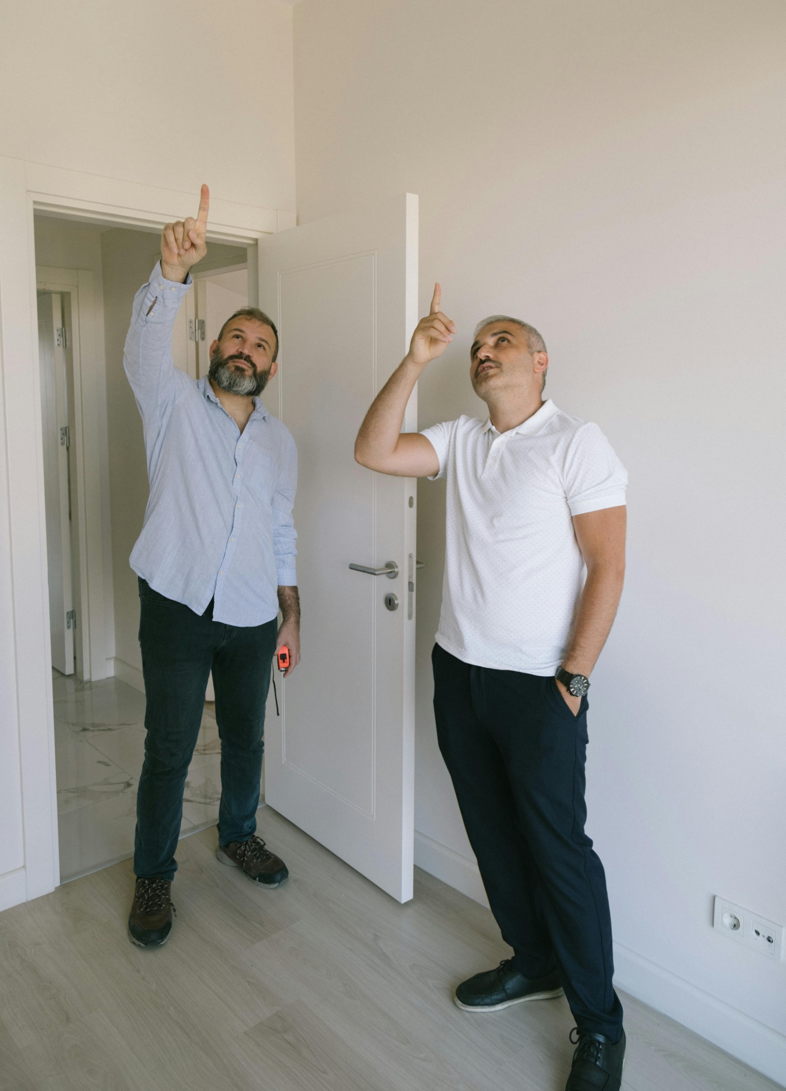 Real estate investor inspects home alongside contractor. 