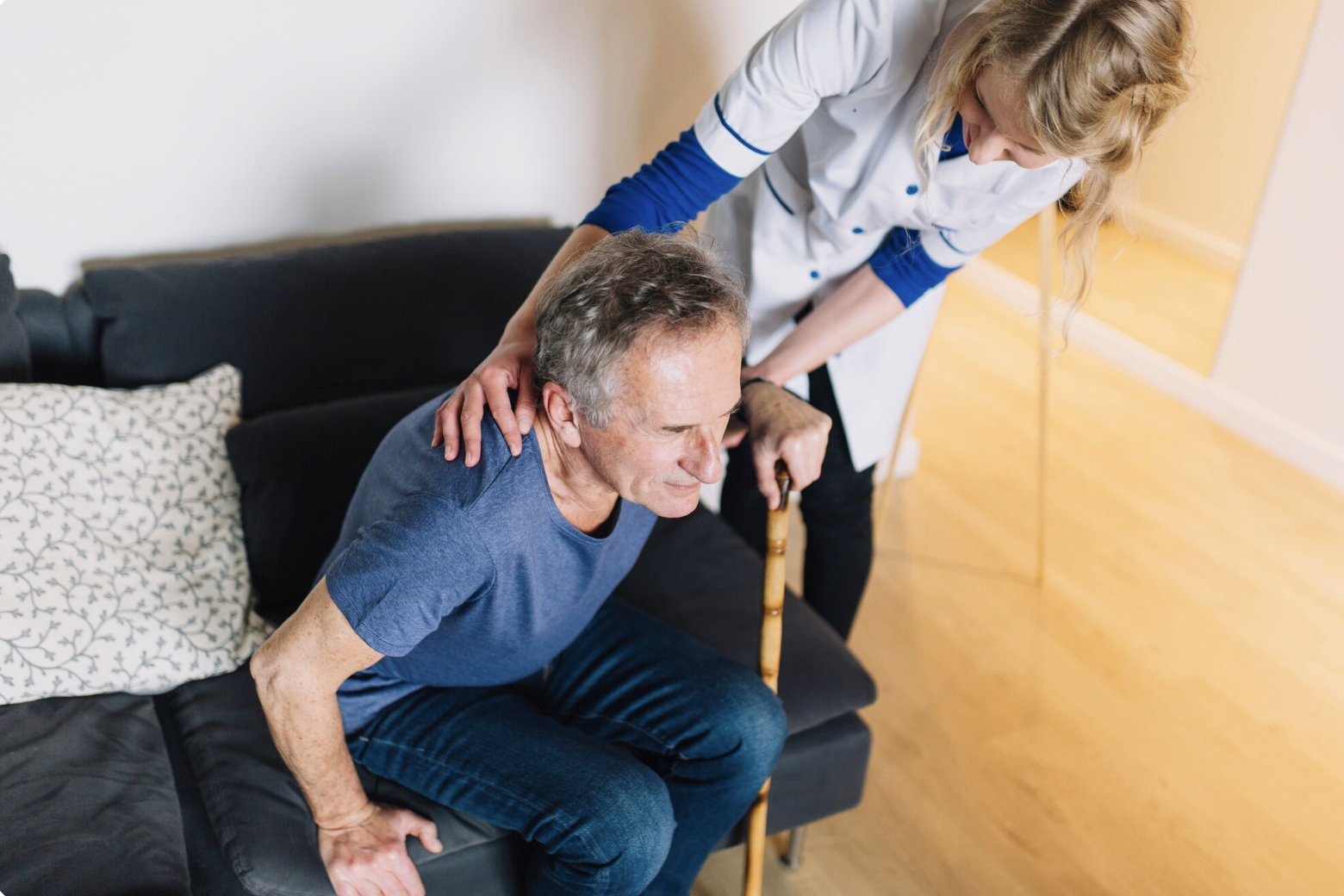 A nurse helping an elderly man