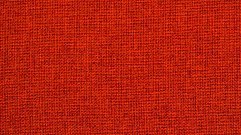 A close up image of an orange lyocell fabric.