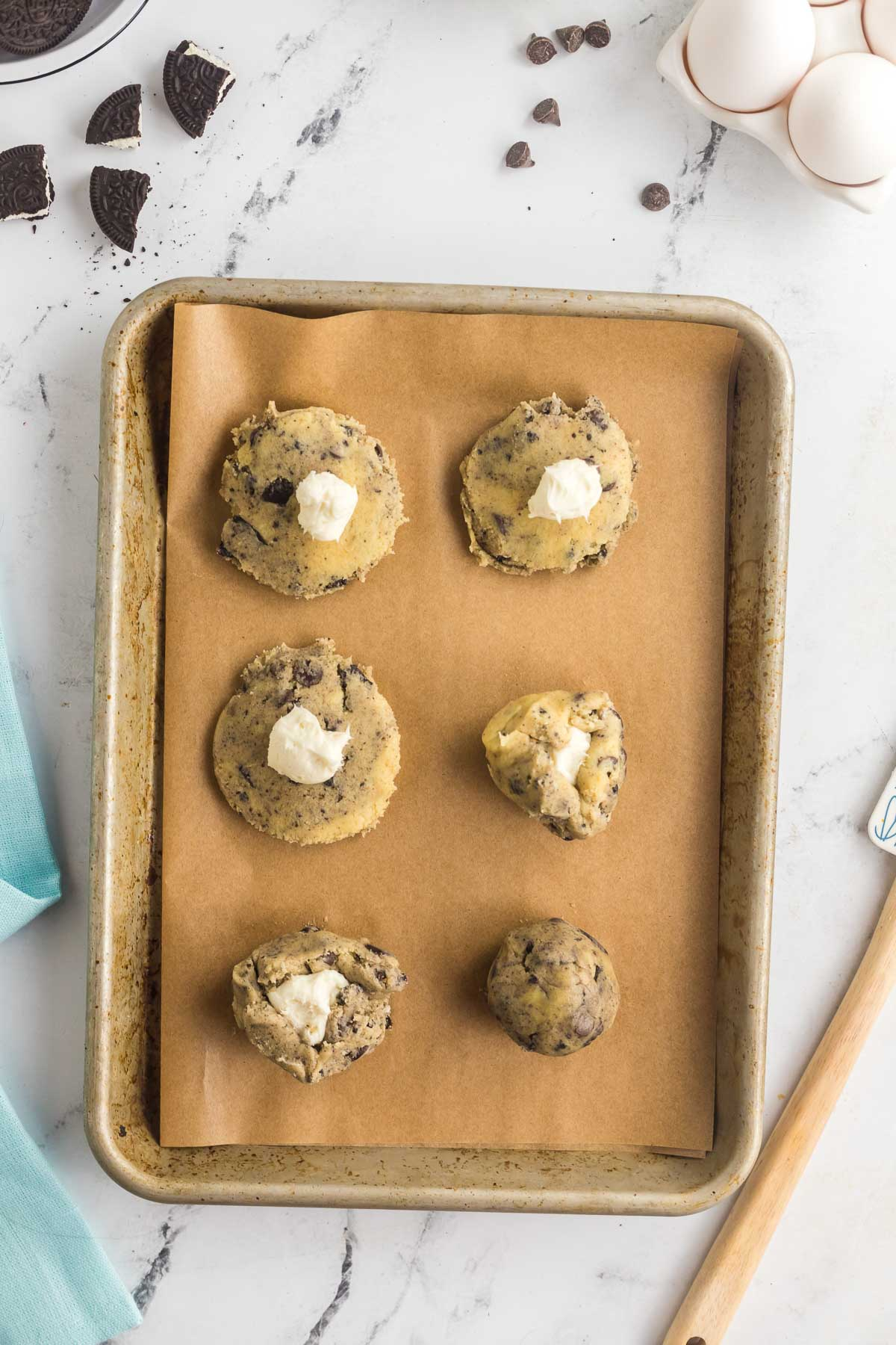 cream cheese filling in center of cookie dough ball and folded up around it