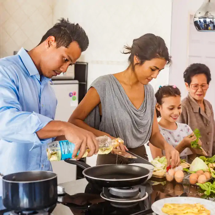 Family cooking together in the kitchen, highlighting the CHINAHERB Supplement Collection, which draws from ancient medical texts and uses thin needles to improve quality of life, available at The Good Stuff Health Shop South Africa
