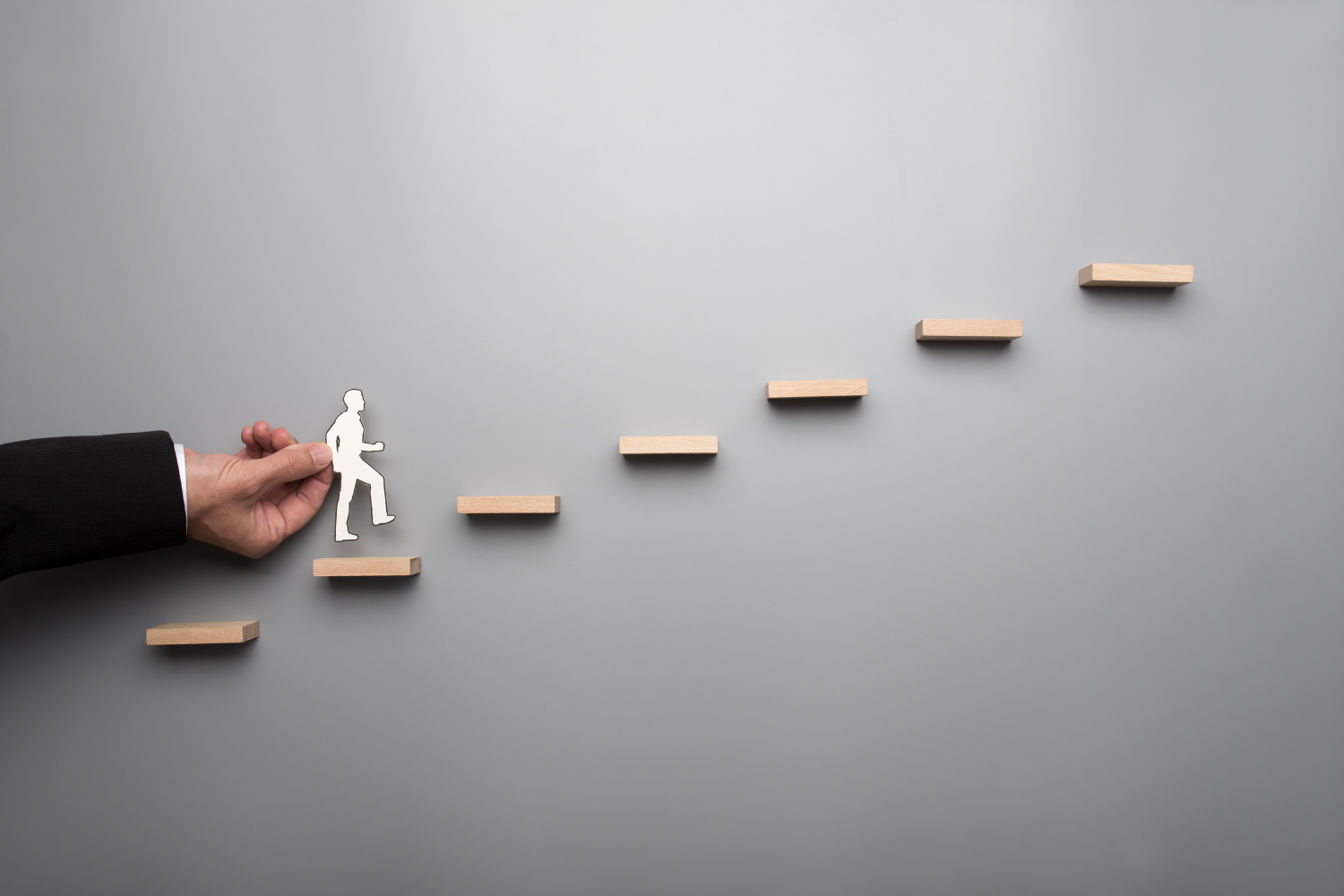 An image depicting a business owner climbing the ladder.