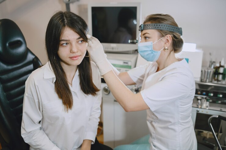 Female patient getting her ear checked