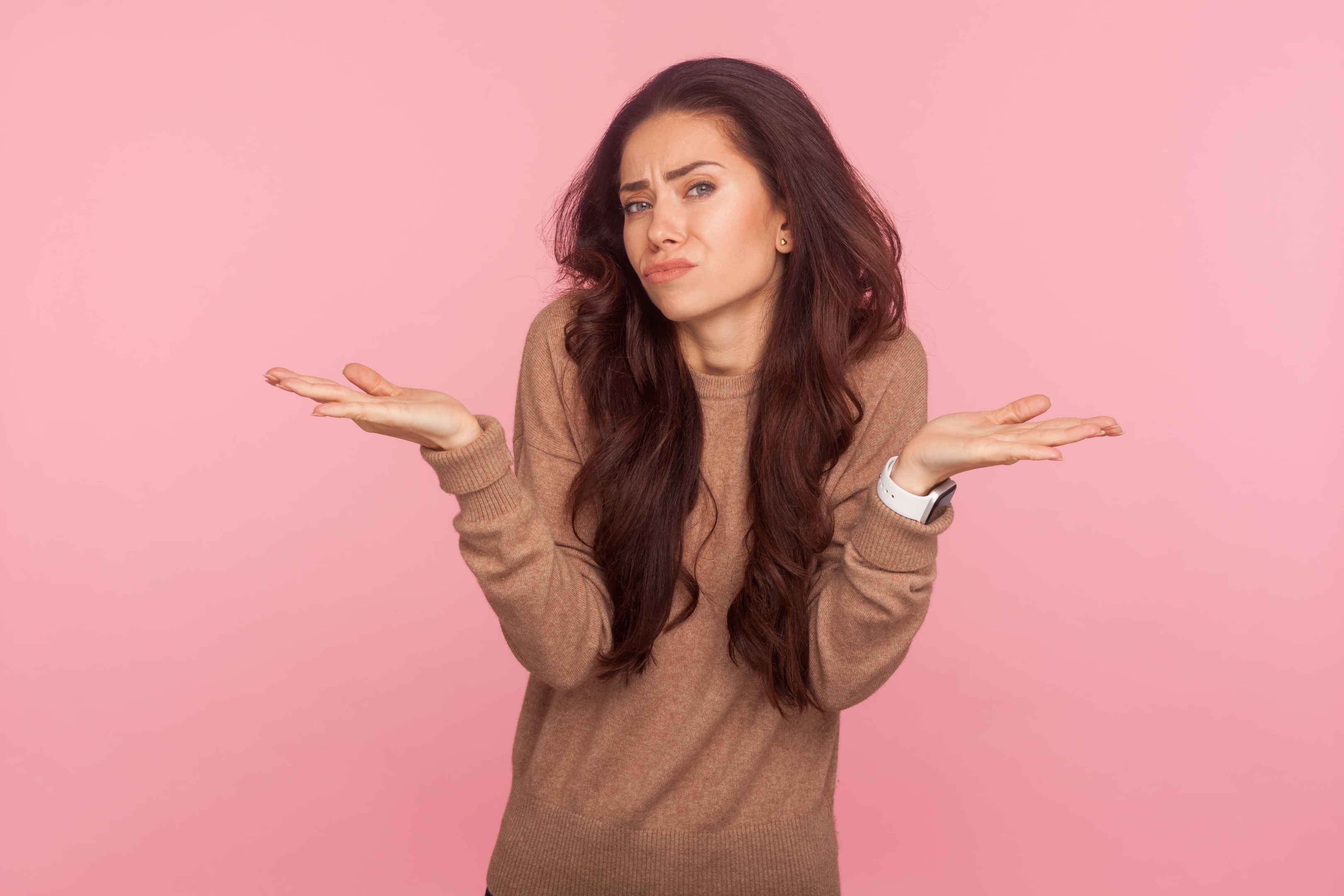 A woman with her hands in the air not really caring about what is happening.