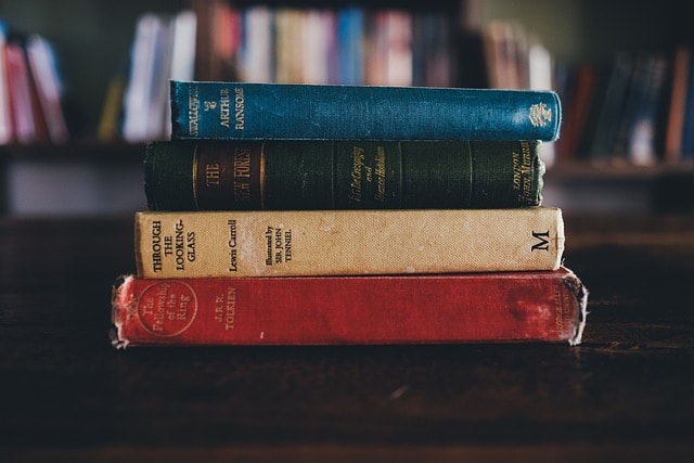 A stack of old books, representing the epistolary form.