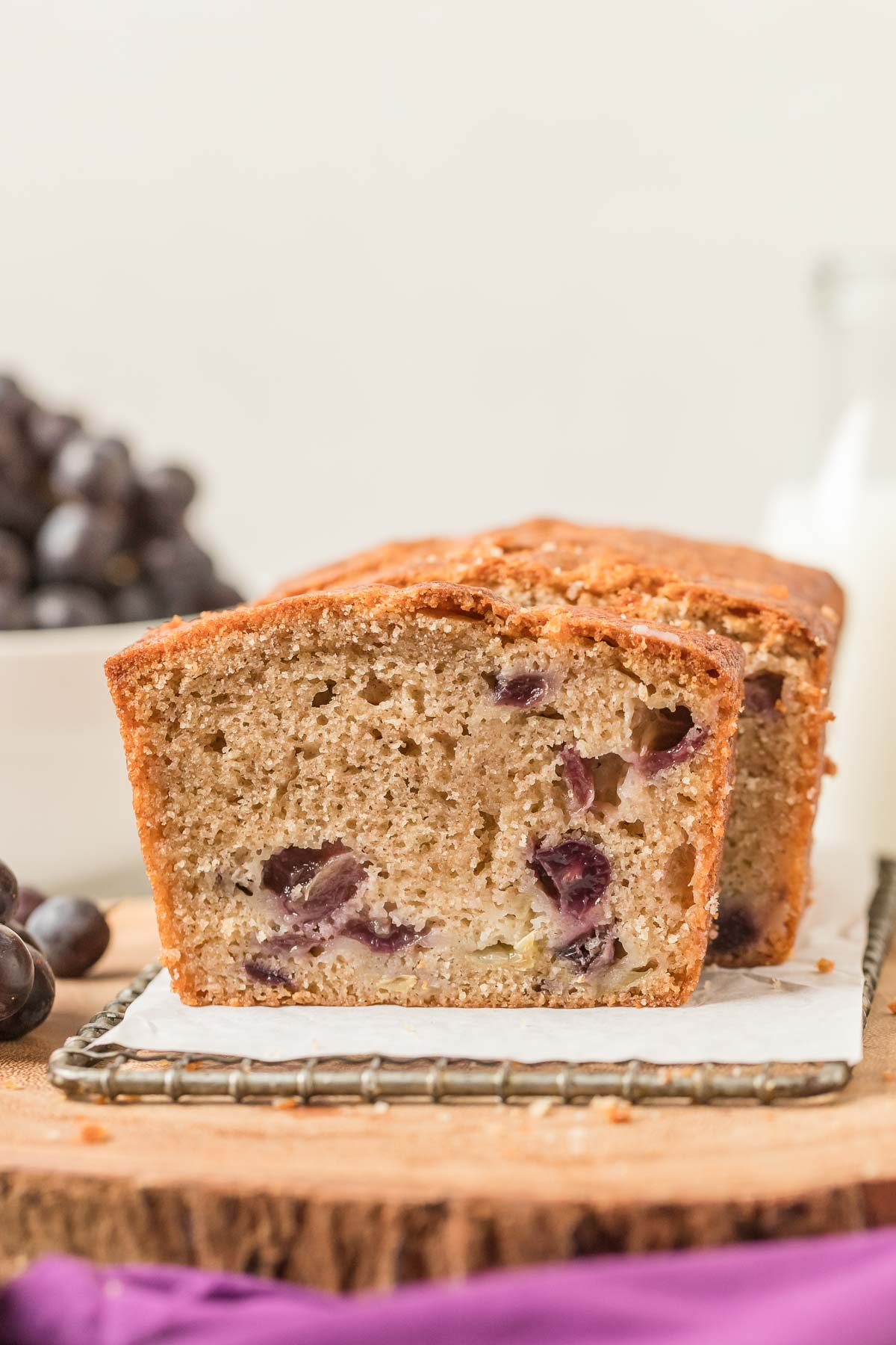 sliced grape quick bread on a wire rack