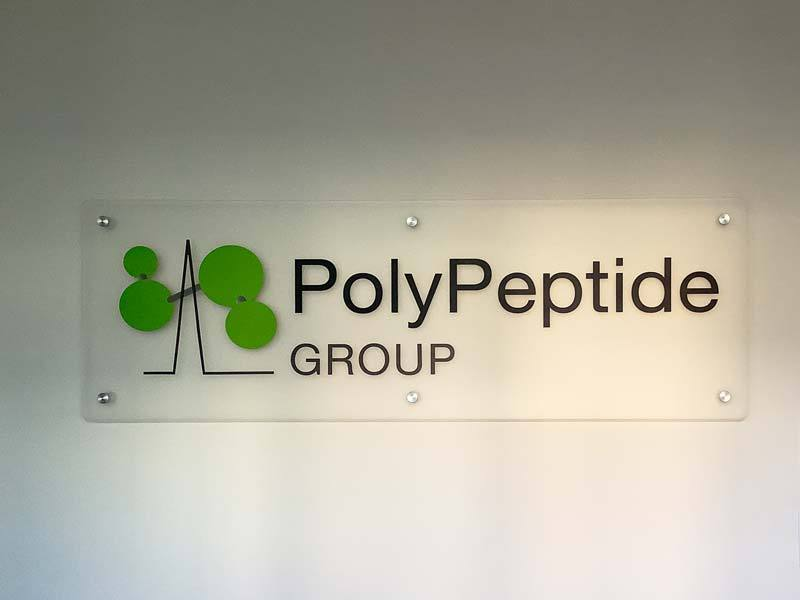 PolyPeptide Group flat sign is a transparent hard plastic sign mounted to the wall located in Torrance, CA.