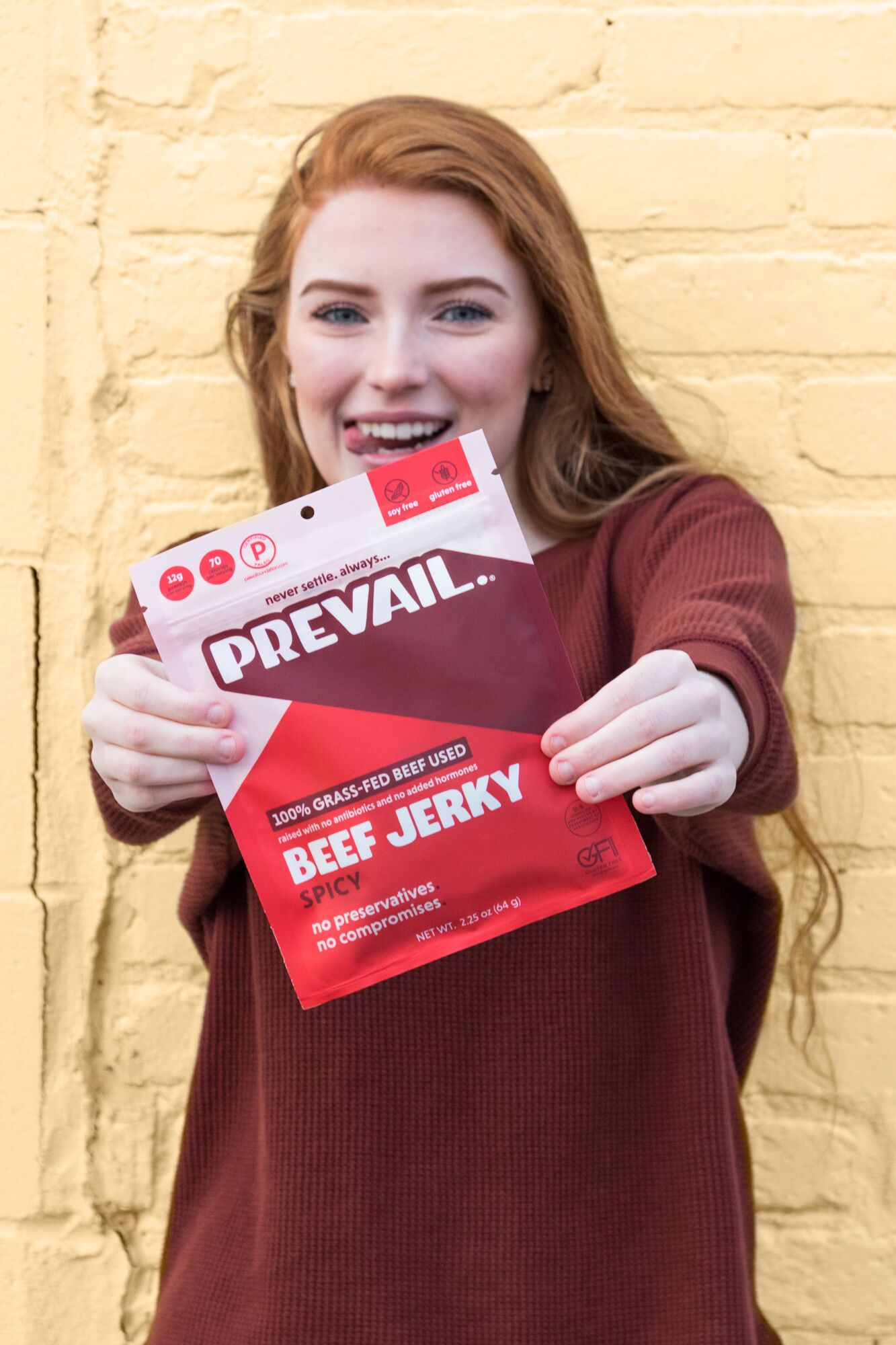 A person holding a package of beef jerky with the ingredients visible