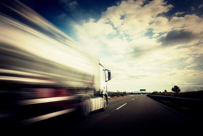 Semi-truck speeding down a highway illustrating the dangers of commercial truck accidents
