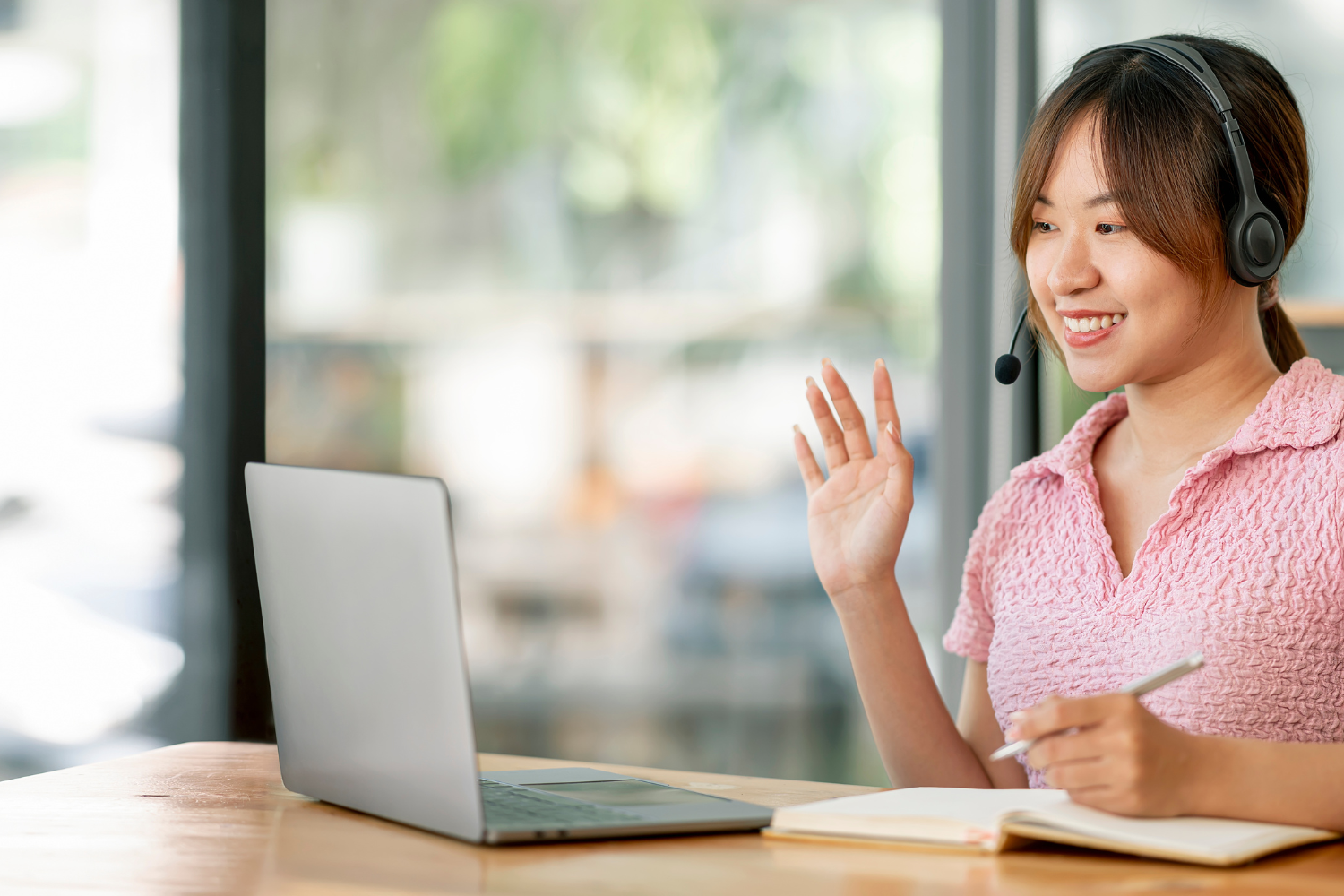A young Filipino job applicant sitting in front of a laptop during a virtual interview.