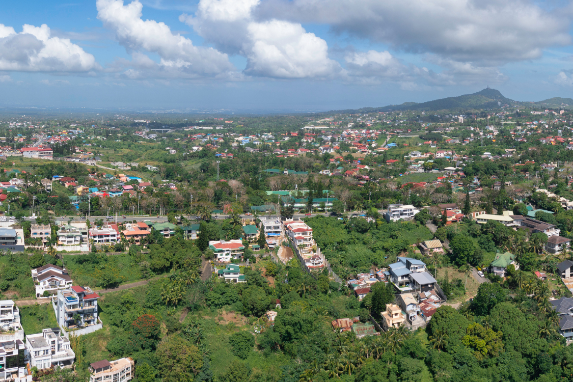 Scenic view of a provincial area in the Philippines with green landscapes and homes