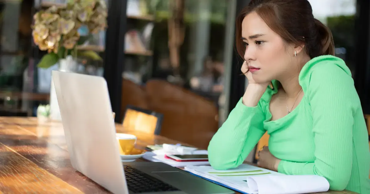 Woman reviewing tax documents after contact from an IRS Revenue Officer.