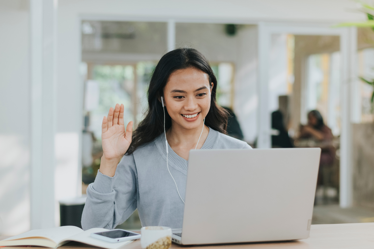 A young Filipino employee listening carefully on video call.