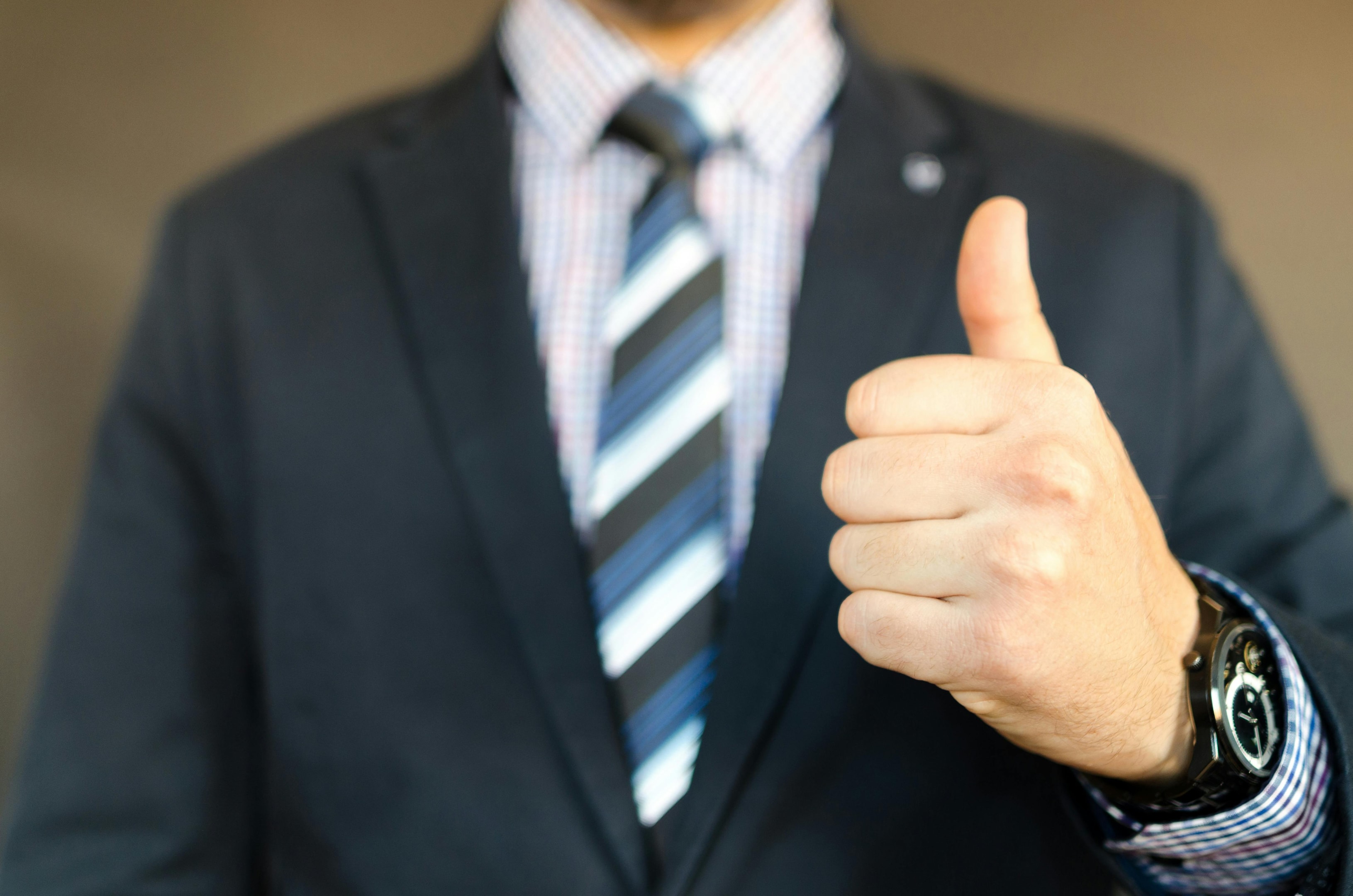 Real estate investor gives thumbs up after closing deal generated through cold calling.