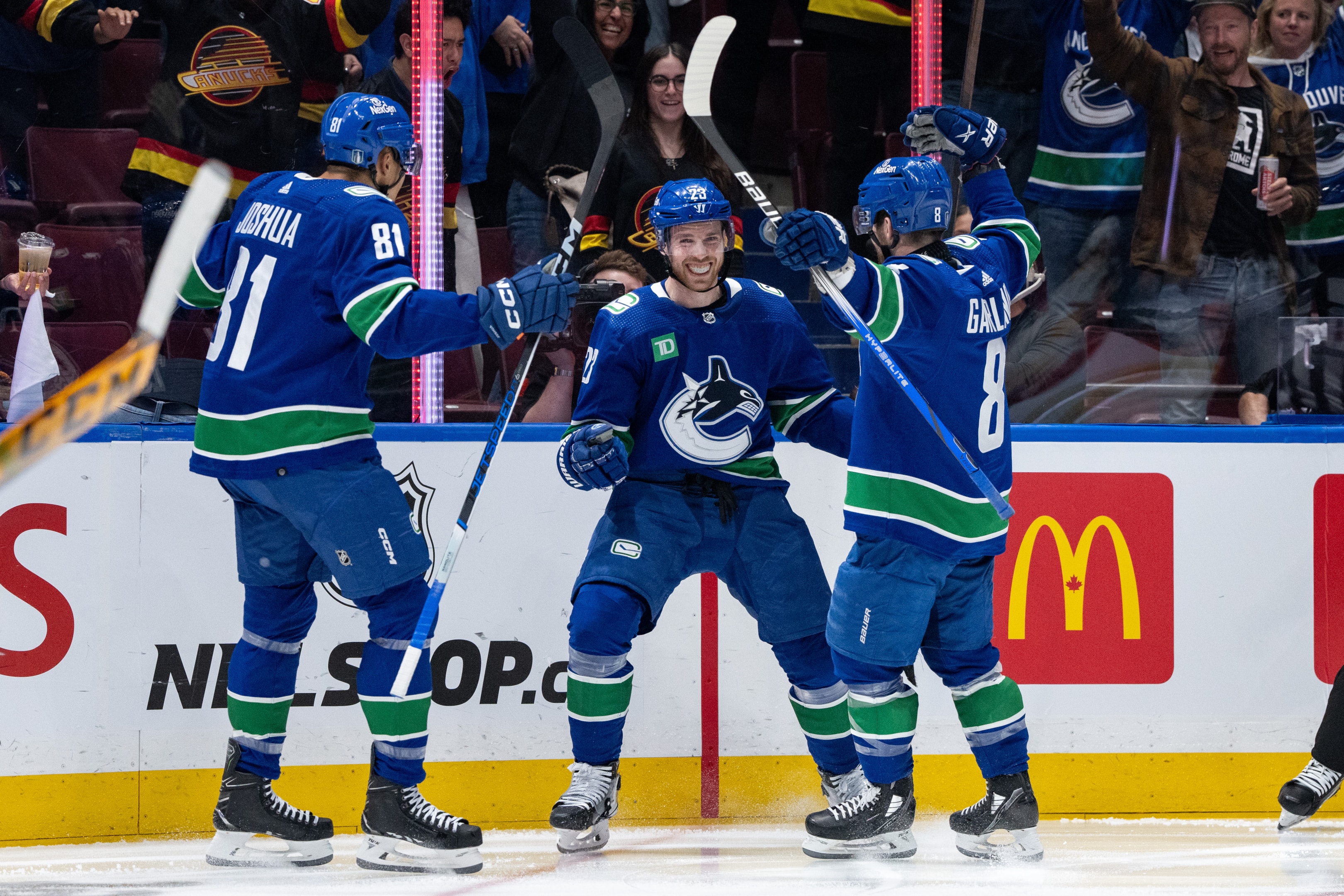 Vancouver Canucks center Elias Lindholm celebrates his goal with center Dakota Joshua and right wing Conor Garland during the First Round of the 2024 Stanley Cup playoffs between the Nashville Predators and the Vancouver Canucks on April 21, 2024, at Rogers Arena in Vancouver, B.C.