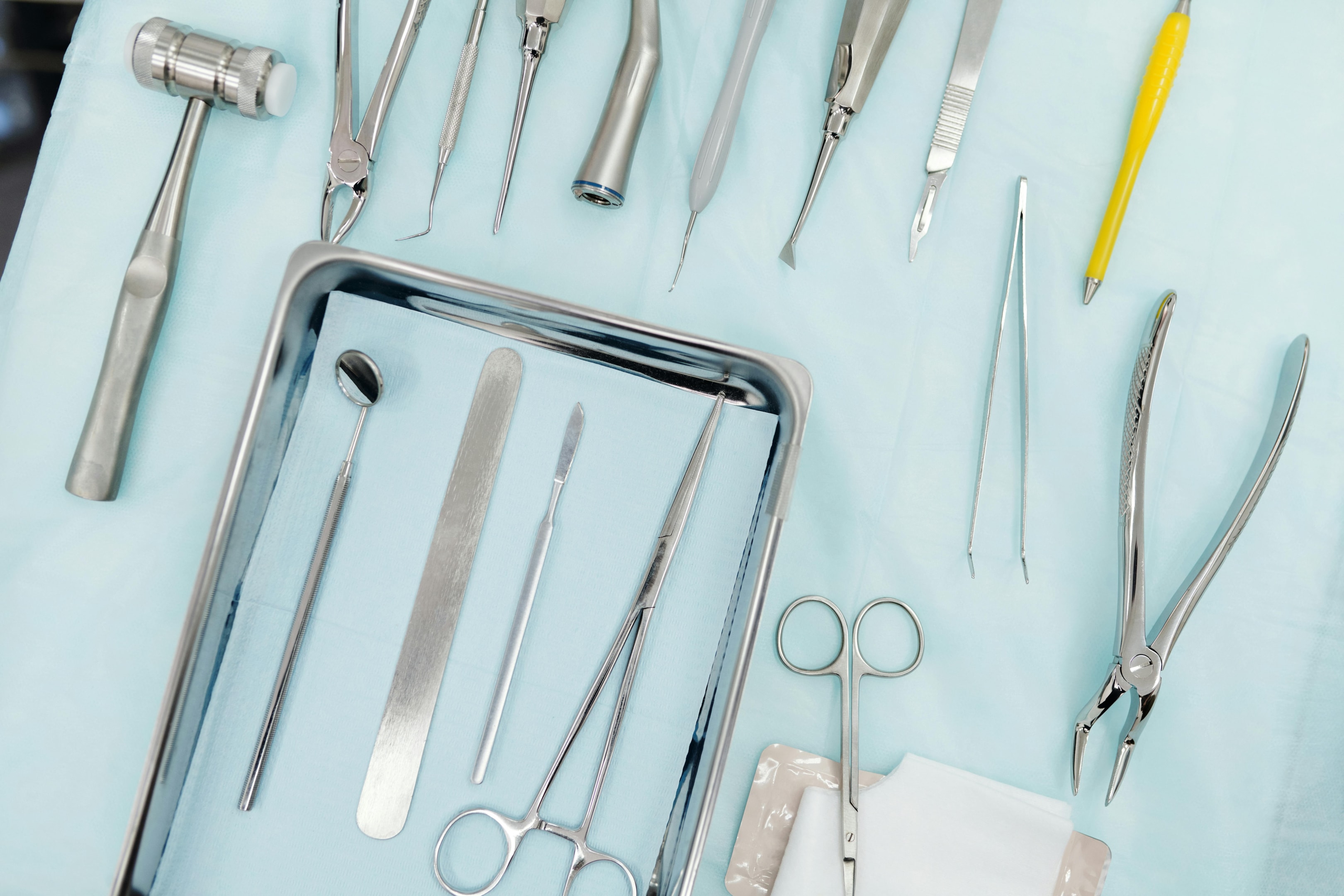 Scissors and tweezers ensure precision in cutting and handling during procedures.