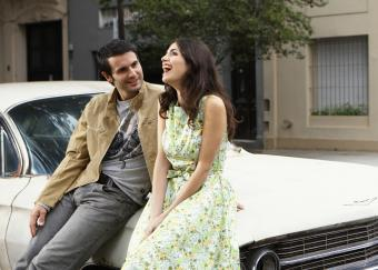 Happy girl dressed in a floral sundress while out with her guy https://dating.lovetoknow.com/How_to_Know_if_He_Likes_You_More_Than_a_Friend