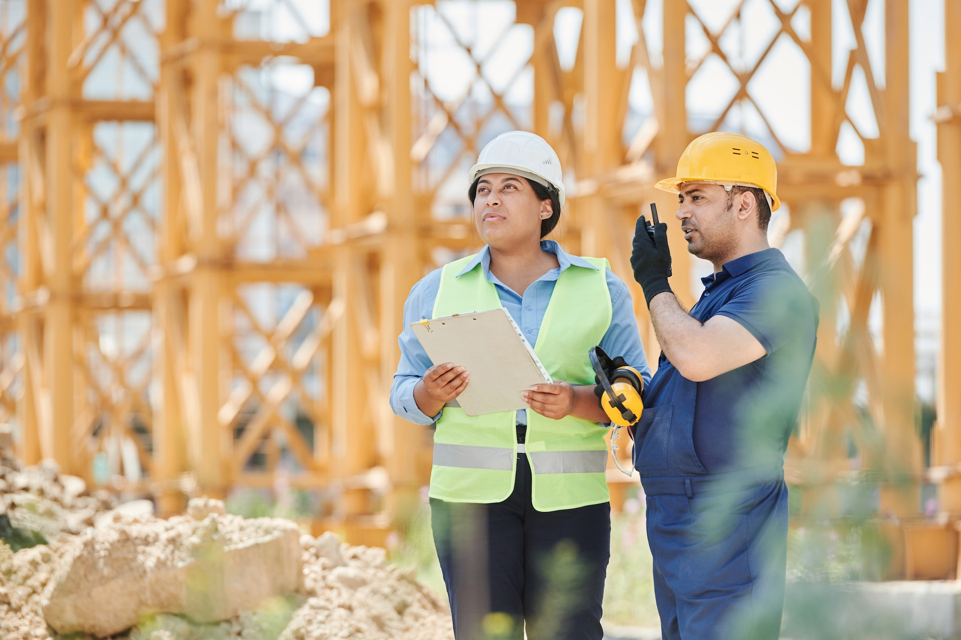 Construction workers in hard hats and safety vests discussing plans