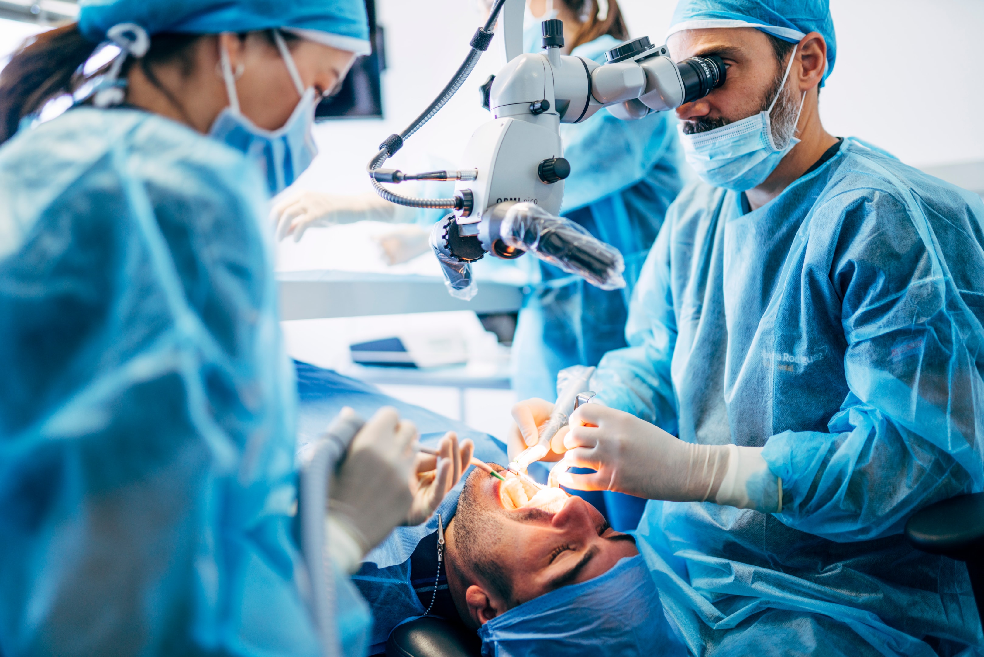 Oral surgeon performing surgical procedure