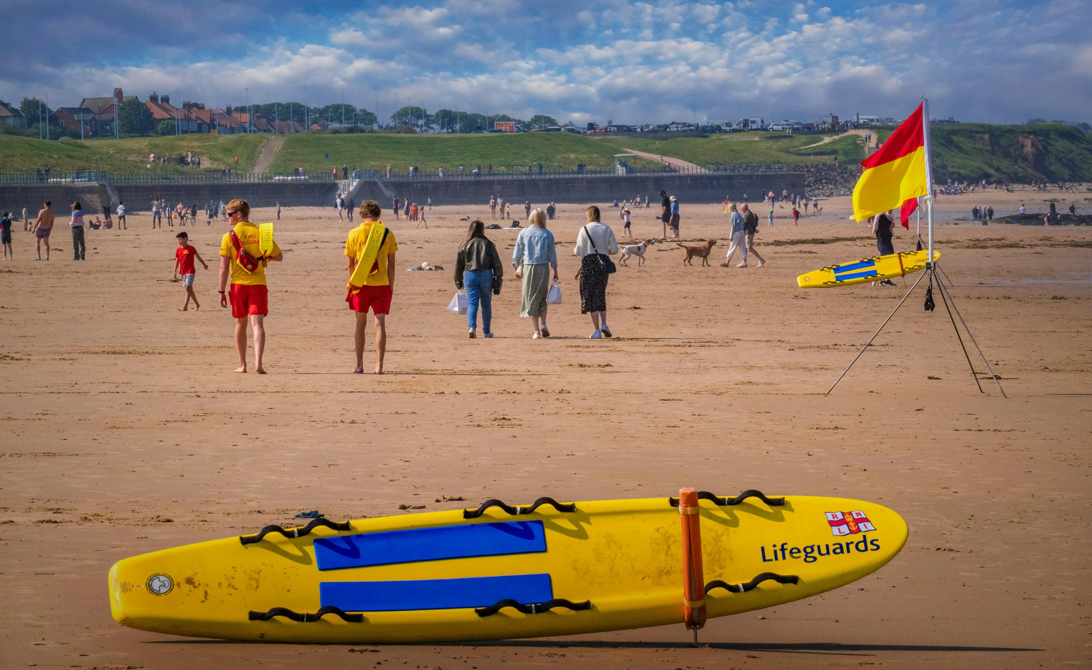 Lifeguards with a spine board, prepared for swift emergency response.
