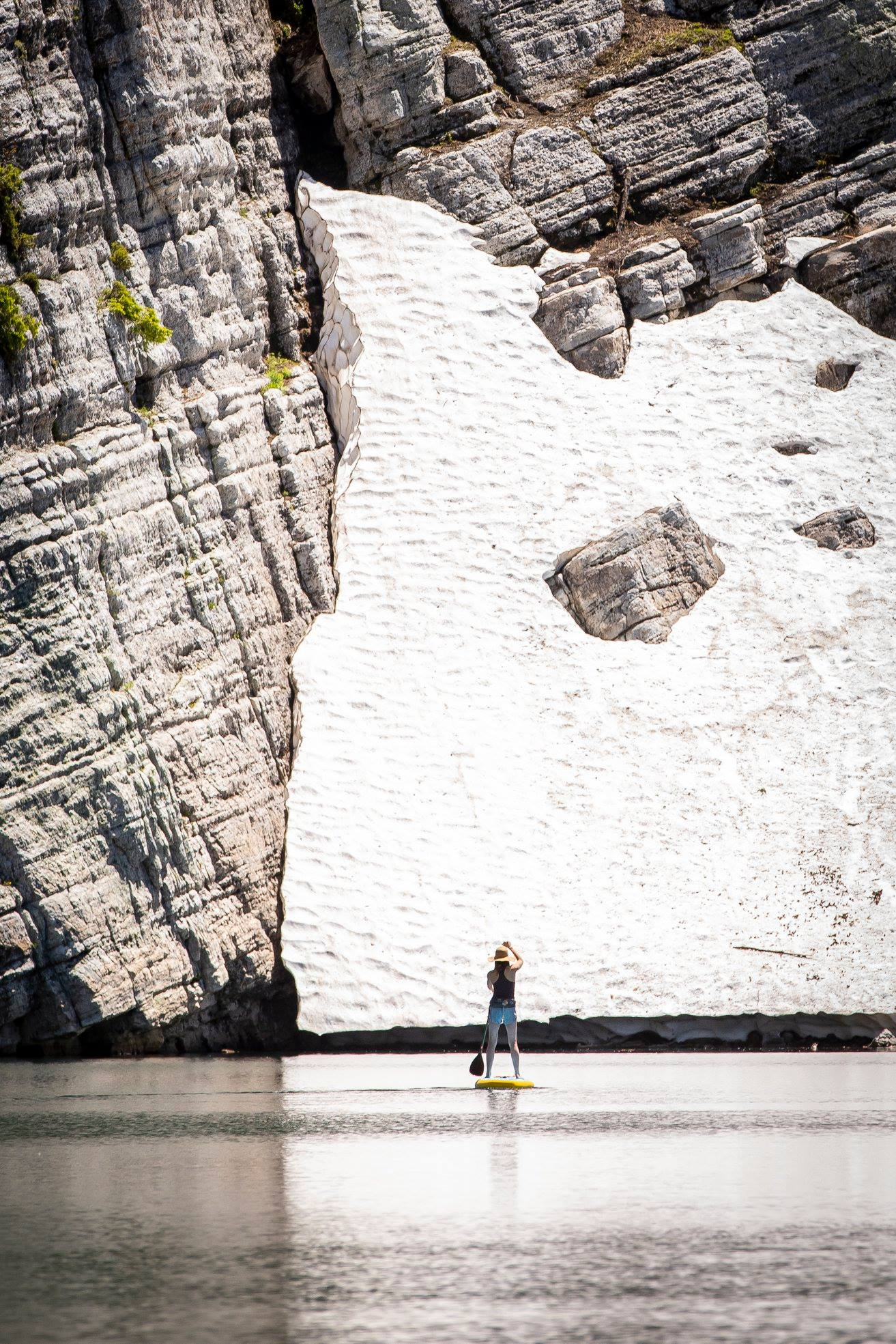 paddle boarder on a stand up paddle board in winter