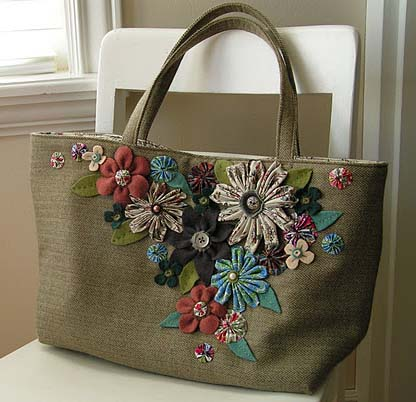 fabric handmade bag placed on a white chair with embroidered flowers