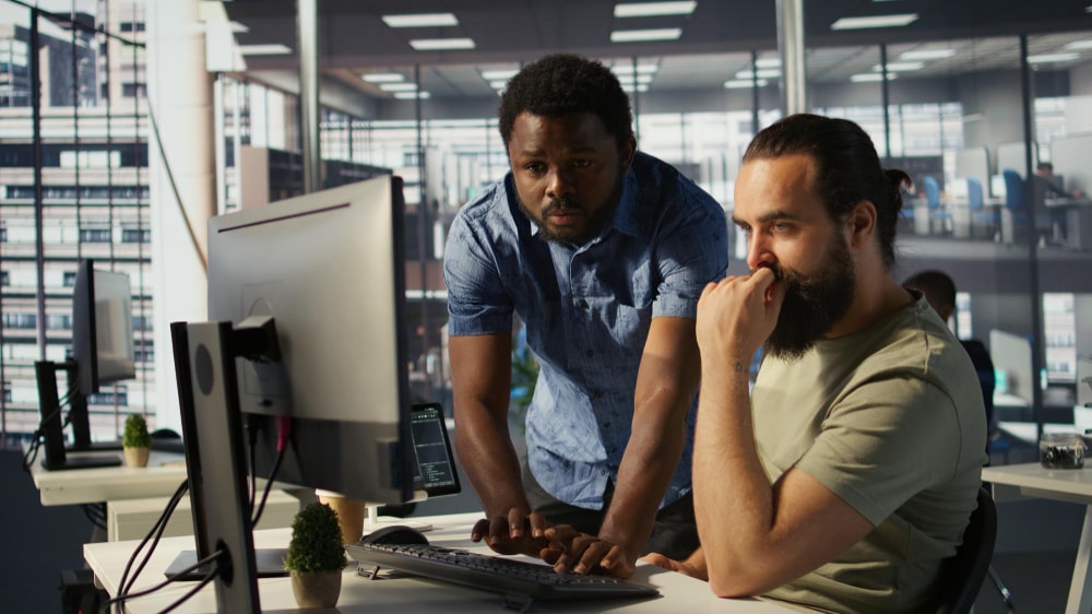 A continuity team member using a computer to run a business impact analysis for potential risks.