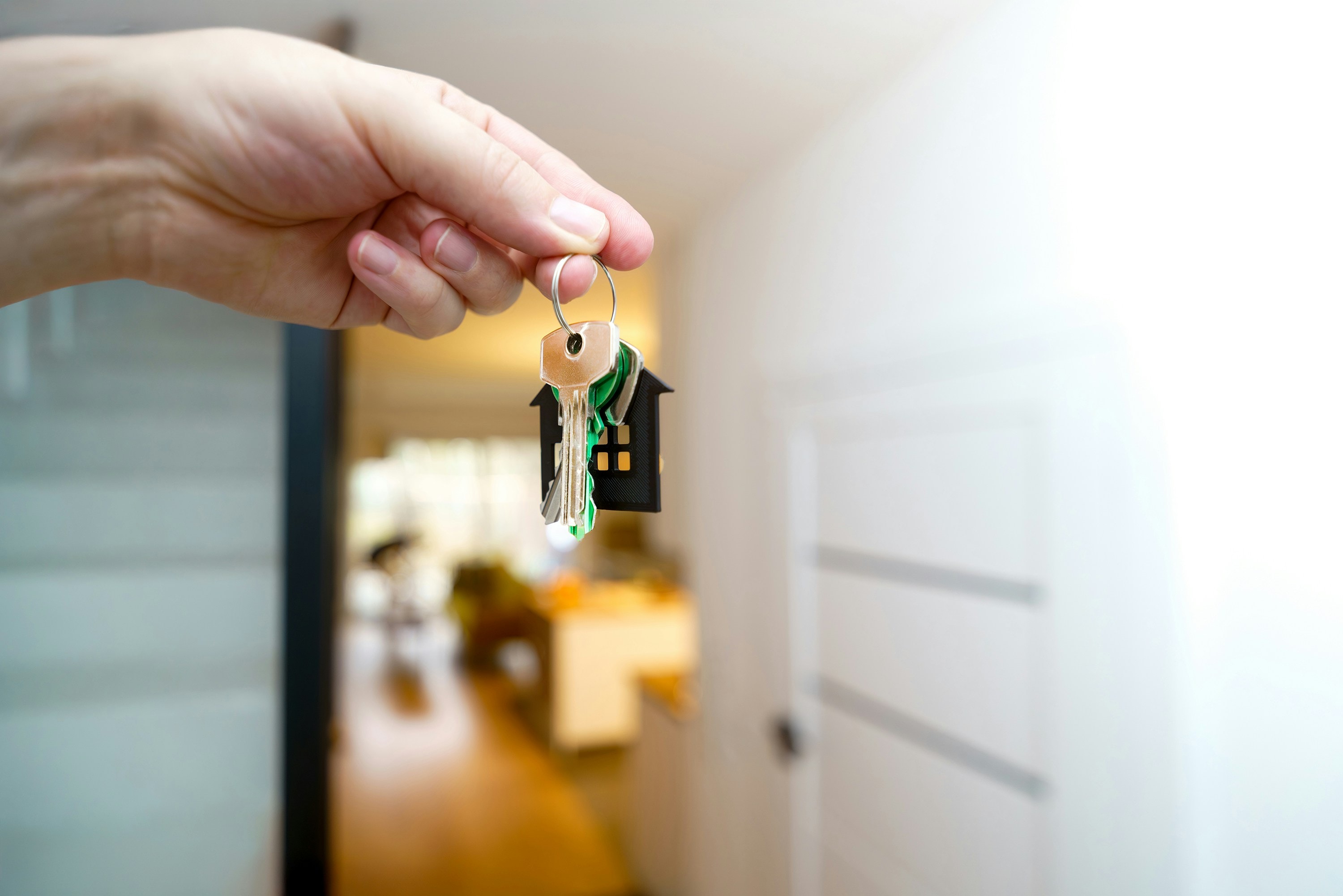 Real estate investor holds keys to newly purchased property. 