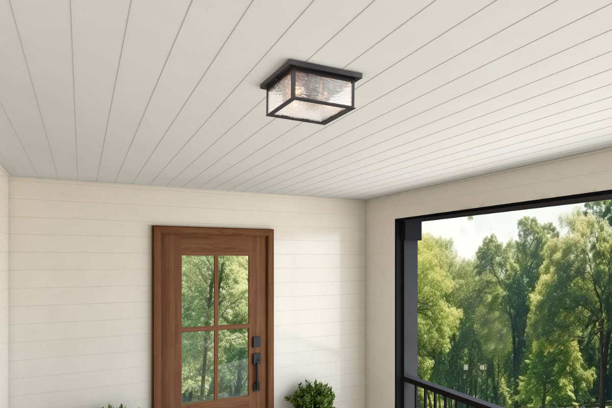 Black square flush mount ceiling light with glass shade on a covered outdoor porch