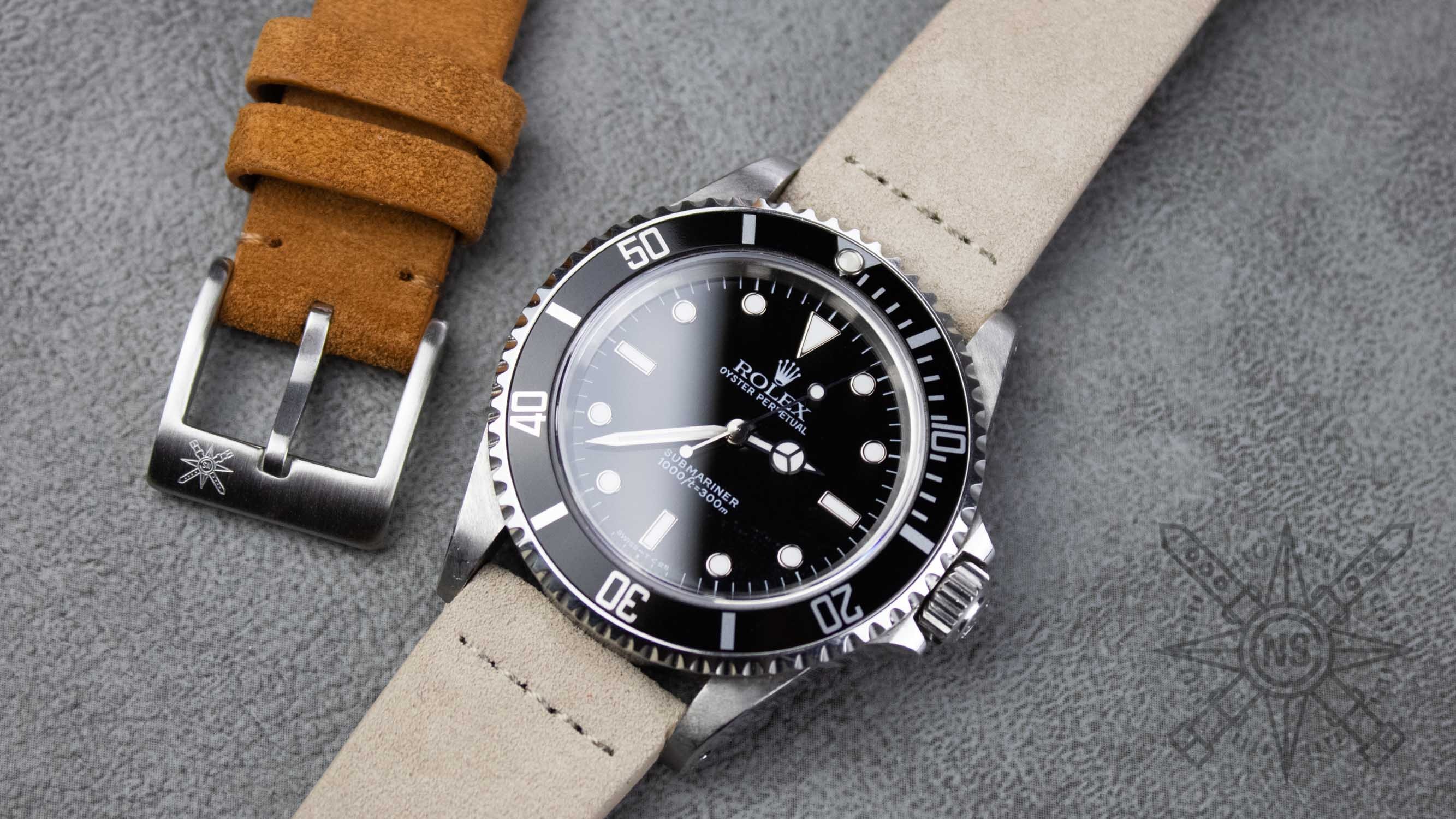 A close-up view of a premium suede watch strap showcases its distinctive napped texture and intricate grain pattern, highlighting the soft and luxurious feel that appeals to watch enthusiasts. The strap is designed for a snug fit and complements various outfits, making it a stylish addition to any watch collection.