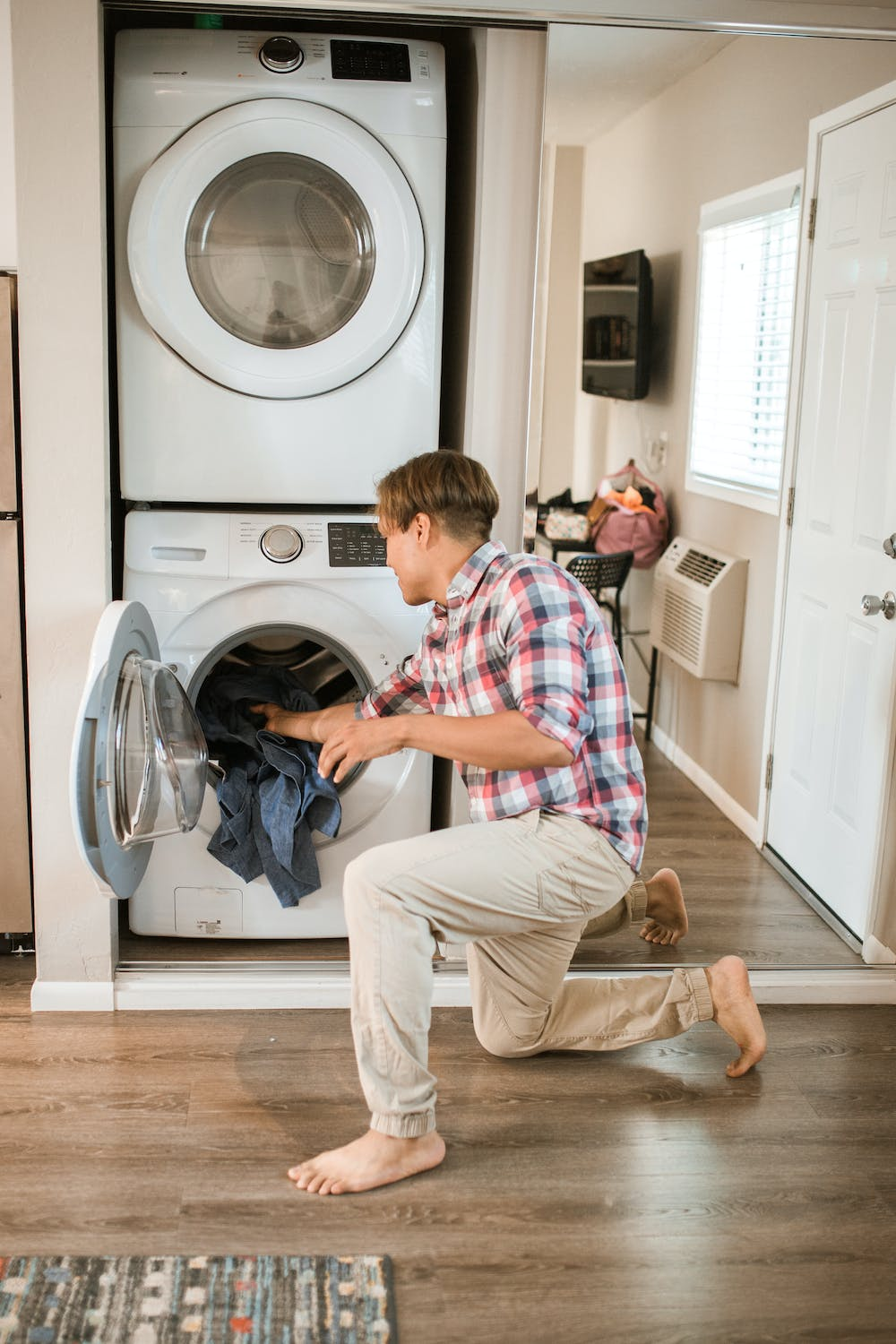 Man Putting Clothes Into Dryer