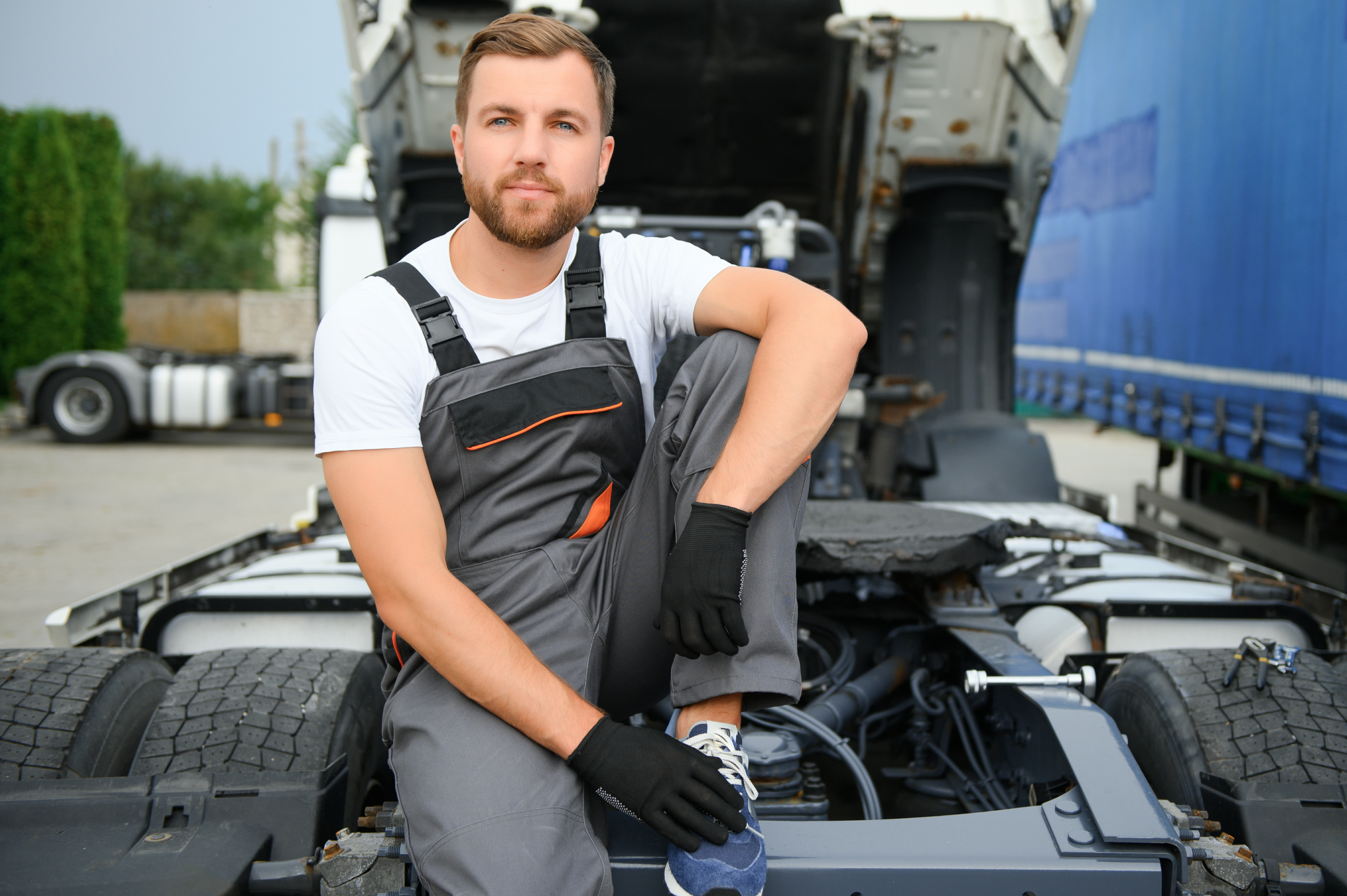 Certified techinician sitting in front of his semi truck