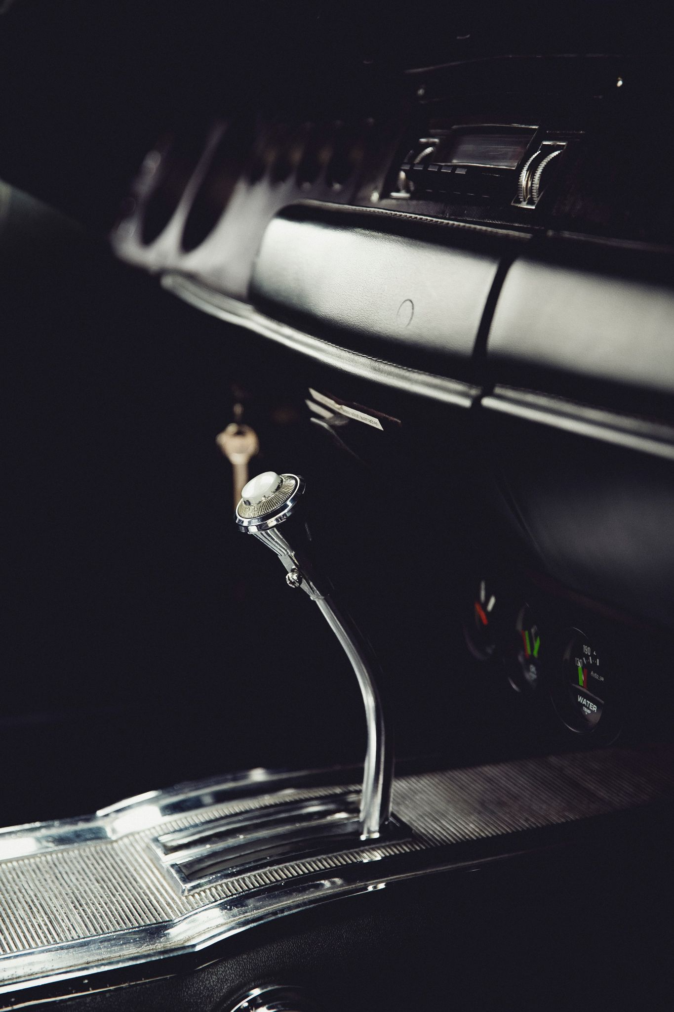 A close-up of a silver gear shifter on a vehicle