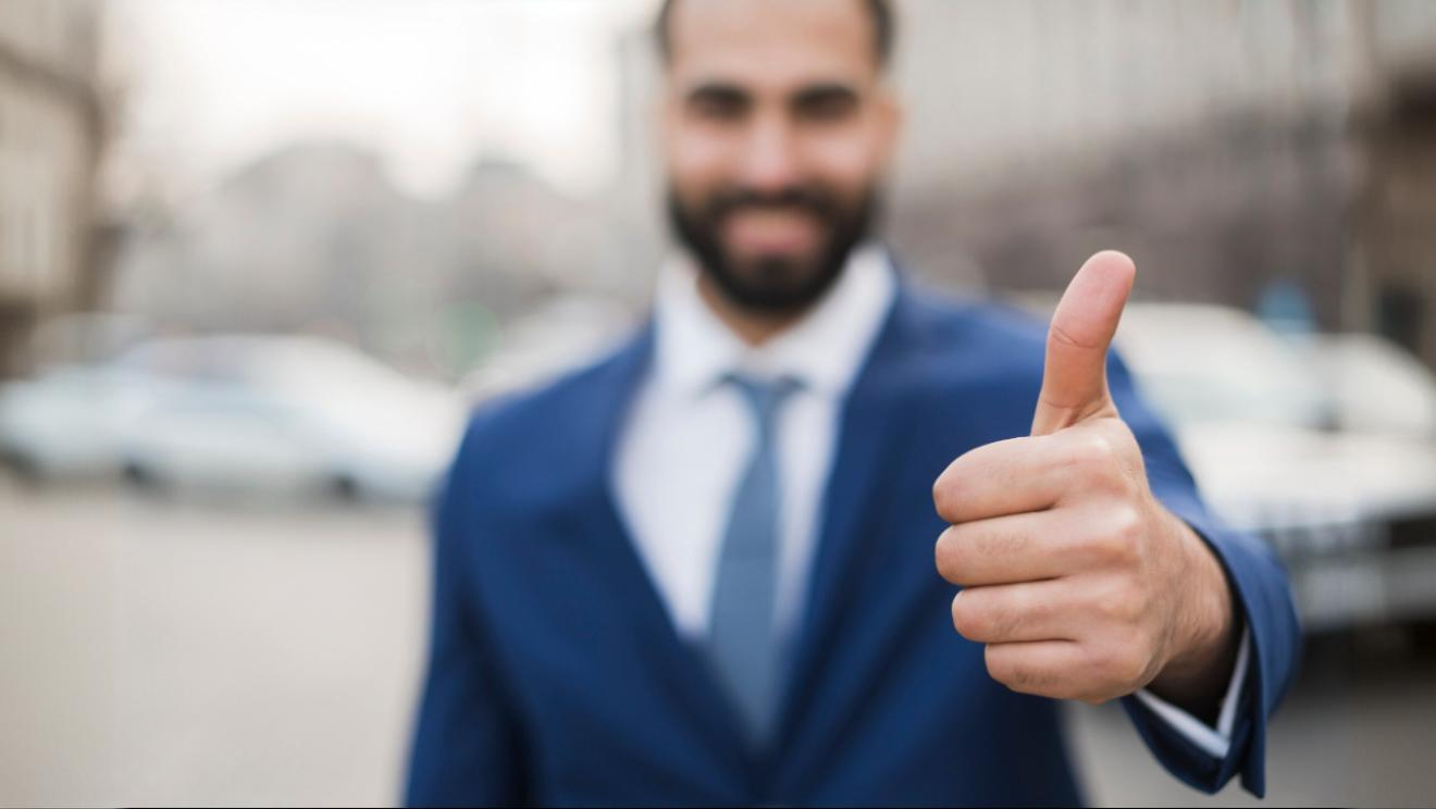 MSP in suit giving thumbs up. Conveying seamless integration to better customer engagement.