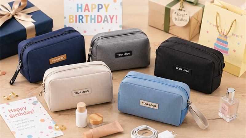 Custom cosmetic bags in assorted colors with logo labels and birthday packaging
