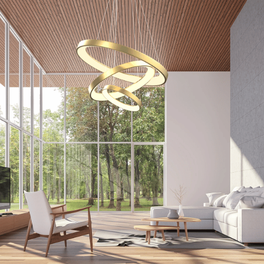 Gold circular pendant chandelier with intertwined rings creating a focal point in a tall modern interior.