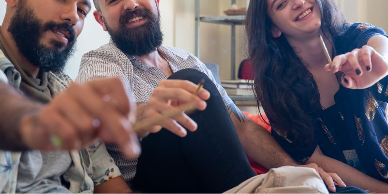 group of people smoking cannabis joints