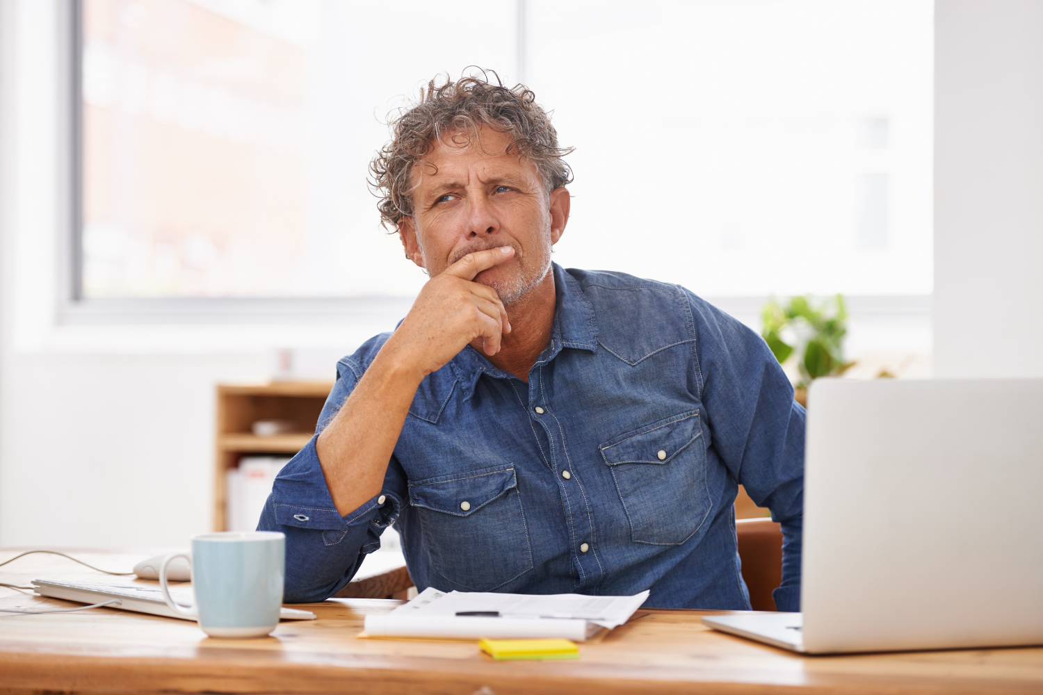 Business owner thinking on his desk.