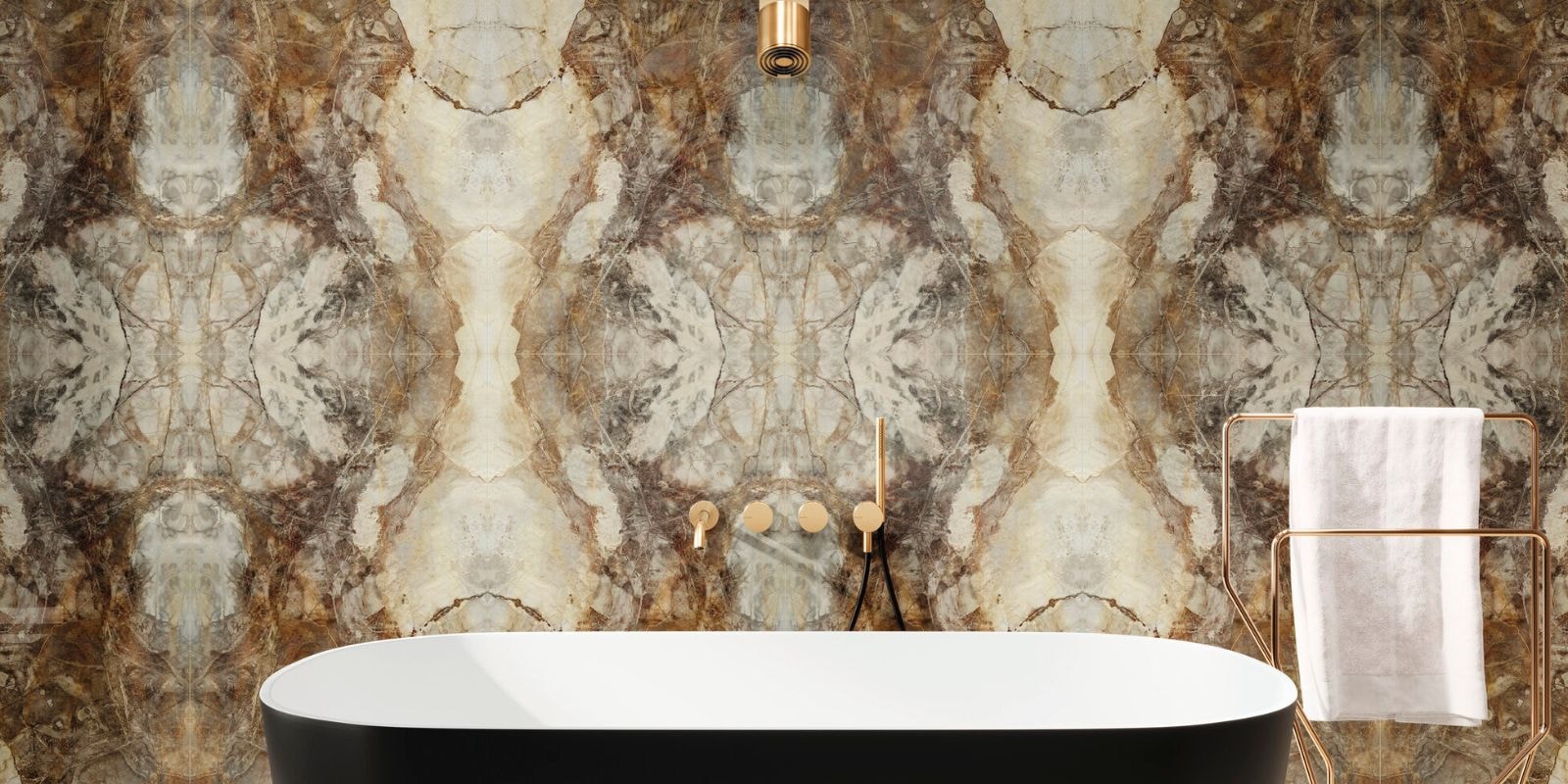 Bold bookmatched marble-effect wall tiles in rich brown, beige, and grey tones, creating a dramatic focal point behind a modern freestanding bathtub.