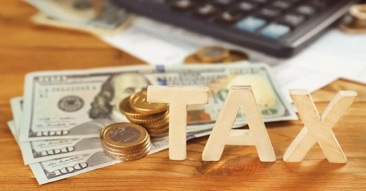 Money, coins, and tax blocks, representing financial planning for taxes and efficiency.