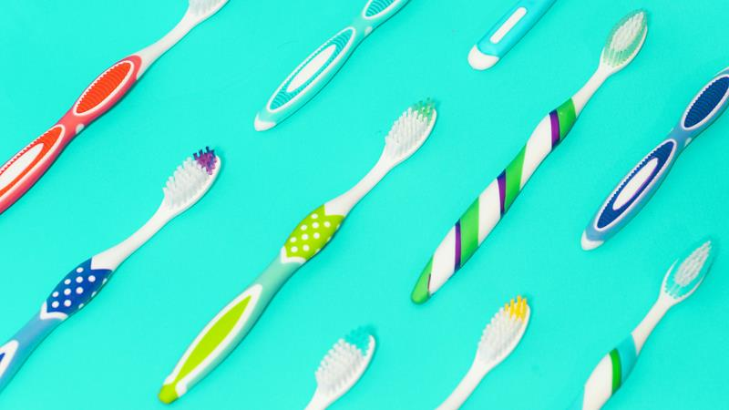 Multi-colored toothbrushes made by multi-shot injection molding