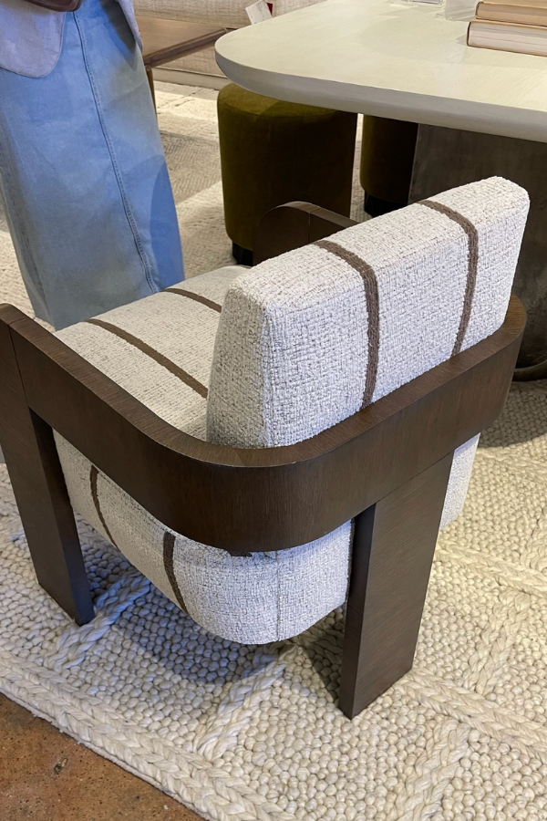 texture and dark wood in an upholstered chair at High Point; luxurious sophistication with a masculine pinstripe