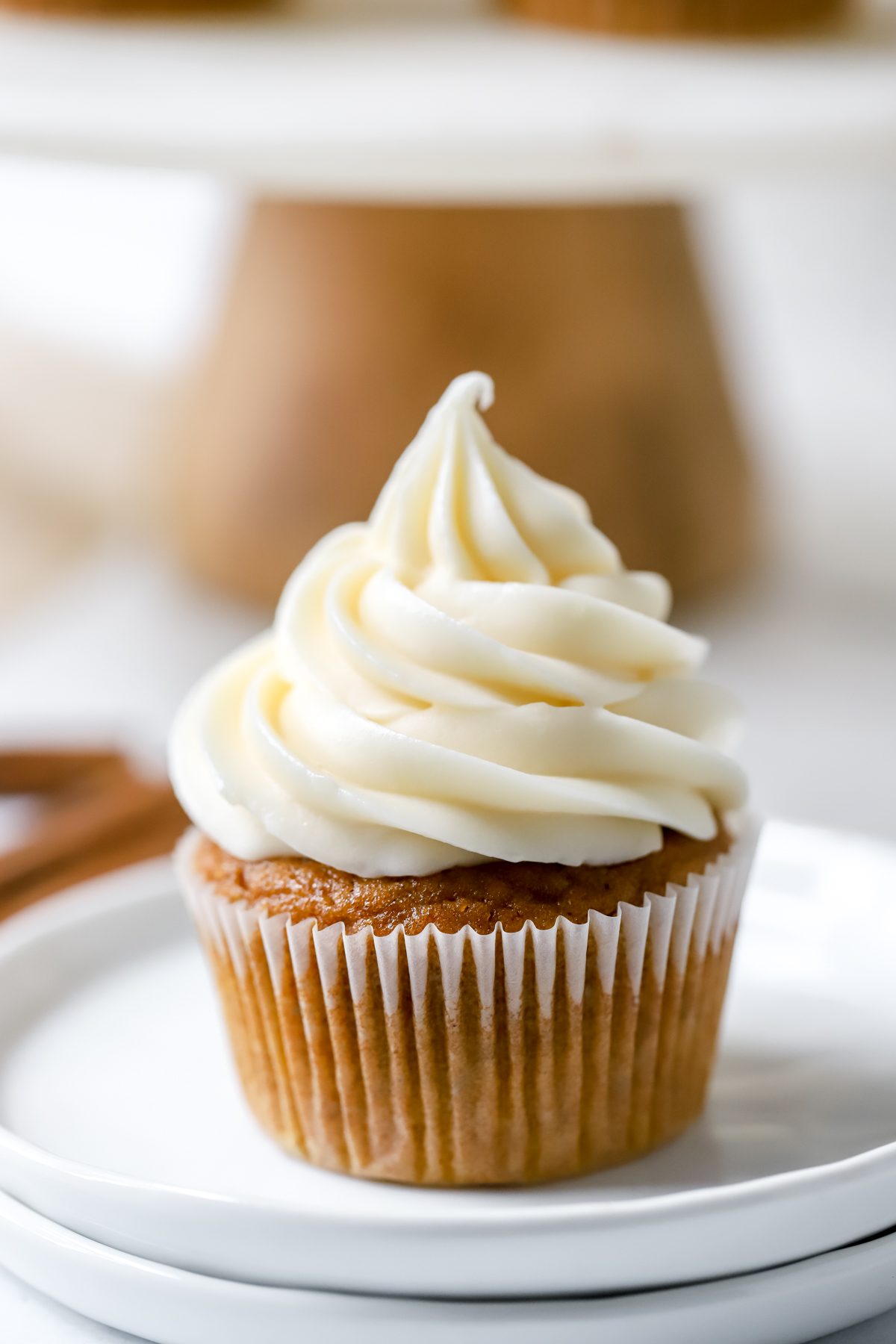 pumpkin cupcake with cream cheese frosting on a plate