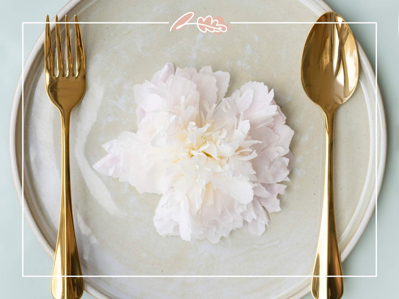 A white peony elegantly placed on a plate with gold cutlery, for '11 Fabulous Reasons to Buy Peonies'