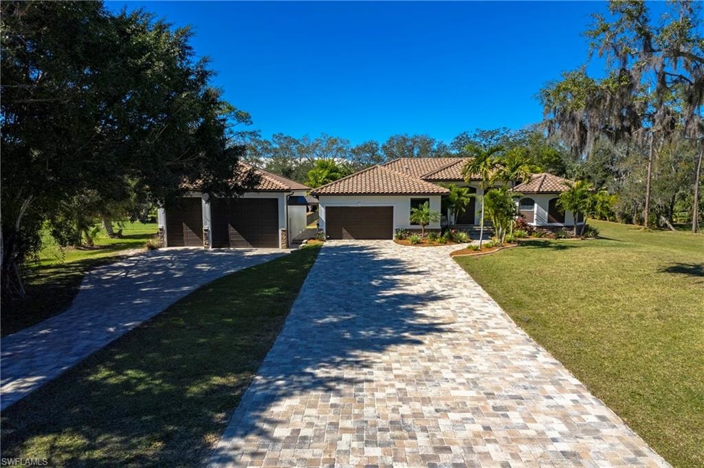 The image depicts a spacious 4000 square foot new construction house from 2025, set on a beautifully manicured two-acre lot in Golden Gate Estates, Naples. The home features an open floor plan with high ceilings, a family room, and a primary suite, surrounded by lush grass and a serene atmosphere, making it a perfect private retreat.