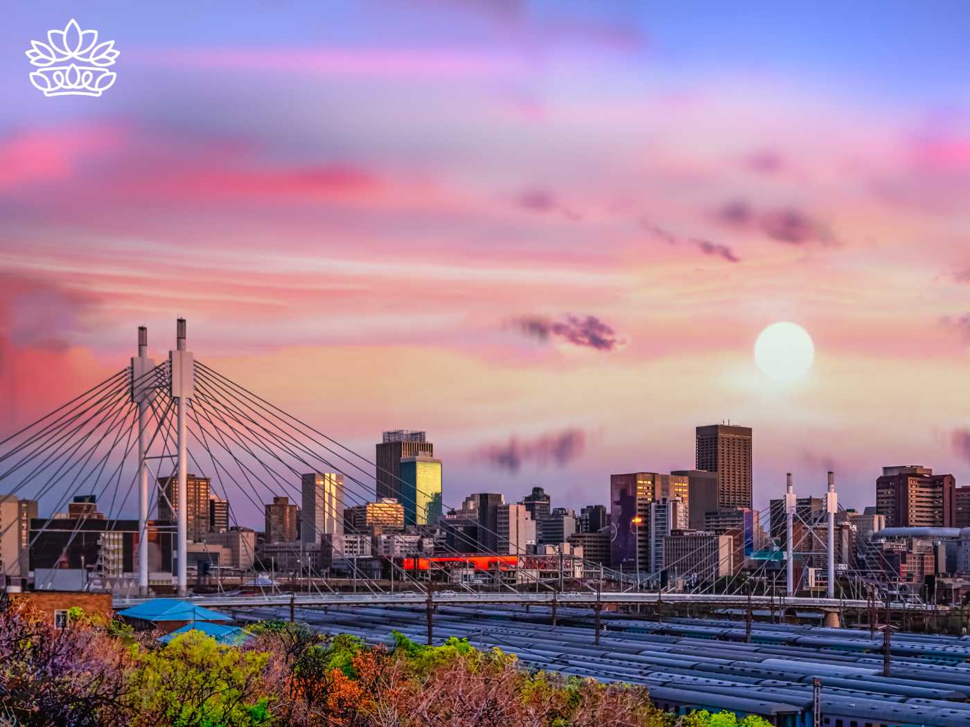Stunning sunset view over Johannesburg, showcasing the cityscape with the iconic bridge, ideal for the Johannesburg Gift Delivery Collection. Offering same day delivery of beautiful flowers, gifts, and hampers, reflecting kindness and thoughtful gift ideas for every occasion. Fabulous Flowers and Gifts.