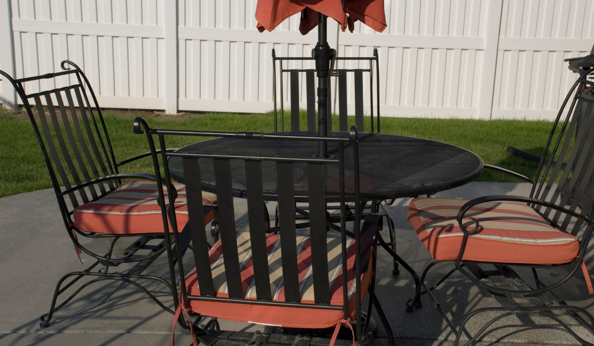 Modern iron patio table and chairs set - black with red and cream tie-on cushions