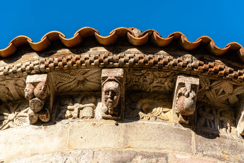 An example of intricately carved, stone corbels used to give distinctive detail on the roof overhang of an old church