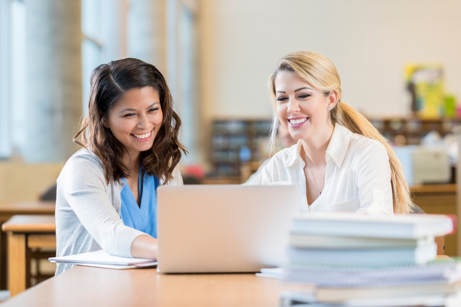 Business owner reviewing broker client feedback on laptop.